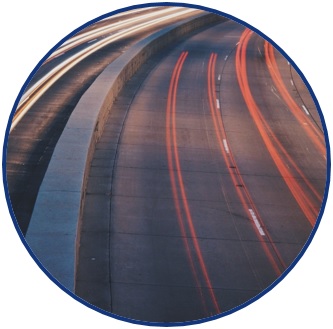 Picture of a highway with streaked red and white colors from vehicle brake and headlights, respectively. The picture symbolizes a wide variety of transportation research areas: safety, congestion mitigation, transportation infrastructure, etc. It is a logo for the research theme of: “Addressing Region 6 Transportation Needs”.